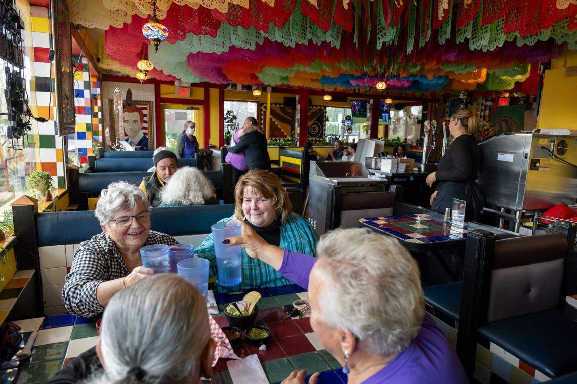 Cheri Collin, left, and Patte Grinnell toast Will Wages and Clarice Hespler as they wait for their meal at Sal’s Tacos earlier this month in West Sacramento. The restaurant is a half-mile walk from Sutter Health Park.