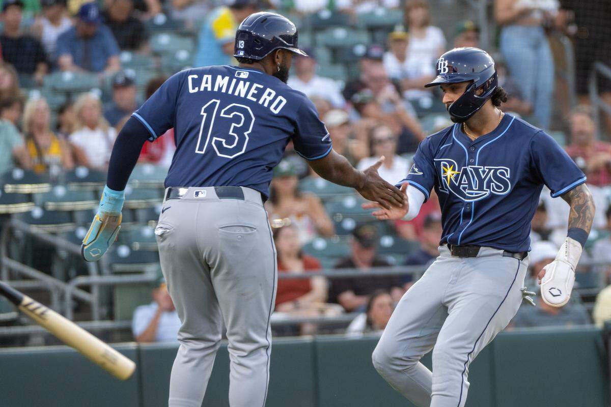 Tampa Bay Rays third base Junior Caminero (13) and Everson Pereira score on a two-run RBI by Tampa Bay Rays catcher Nick Fortes (40) in the second inning during a game at Sutter Health Park in West Sacramento on Monday. 