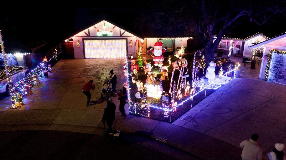 Spectators take in the Christmas lights at Dovewood Court in Orangevale on Monday Dec. 9, 2024. The 18-home cul-de-sac has been a known for its elaborate holiday decorations since the 1980s.