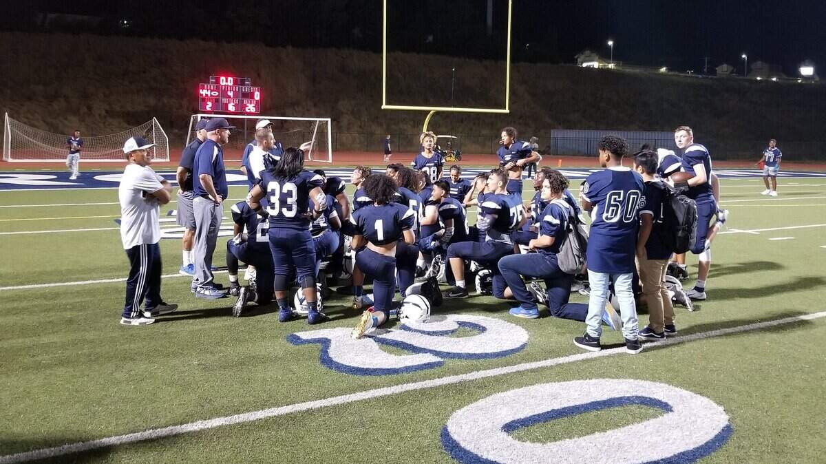 Rosemont players and coaches gather on the field after thumping McClatchy to open the season for both teams Friday night.