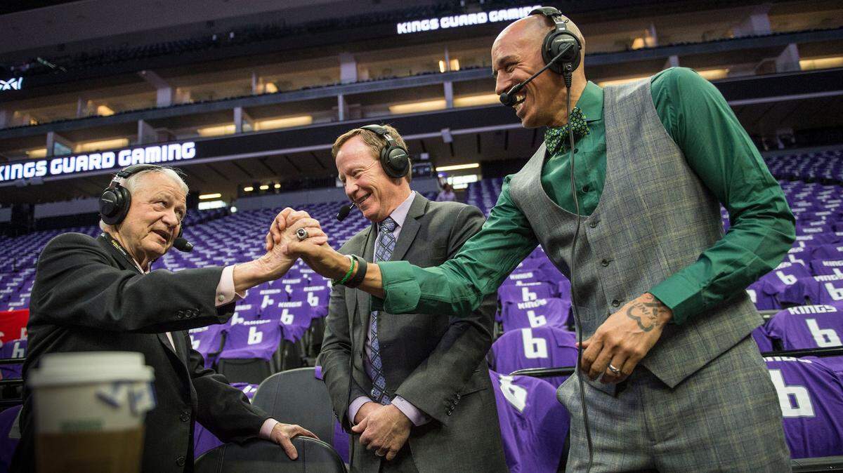 Jerry Reynolds, left, greets former Kings player Doug Christie before last season’s final game April 11 at Golden 1 Center. Christie is replacing Reynolds as the team’s color analyst and will join play-by-play announcer Grant Napear, center, on NBC Sports California.