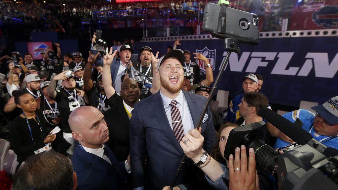 Kolton Miller takes a selfie with fans as he celebrates being selected by the Raiders during the NFL draft Thursday in Arlington, Texas.