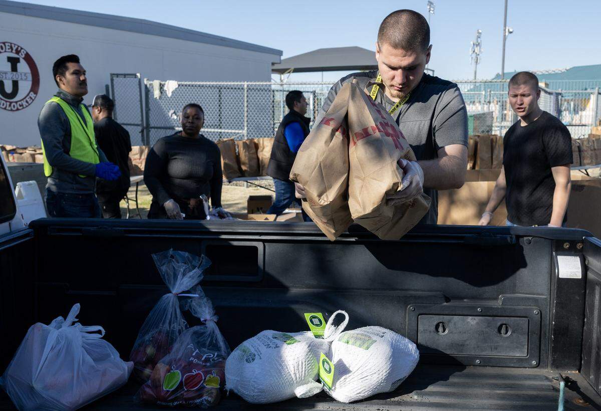Charles Dankoff helps distribute food with other volunteers at Joey’s Food Locker, a program run by the Natomas Unified School District, on Friday in Sacramento. The program is set to distribute Thanksgiving meals to more than 1,000 families.