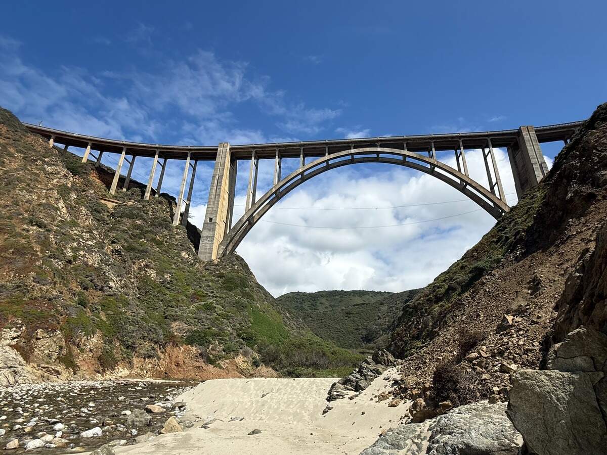 The 2.61-acre parcel is tucked in a canyon where Bixby Creek runs year-round and Bixby Bridge arcs above the California Central Coast shoreline in Big Sur.