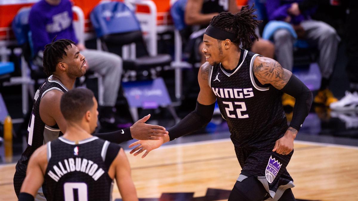 Sacramento Kings center Richaun Holmes (22), right, is congratulated by teammate Buddy Hield (24) after Holmes scores in the second period against the Denver Nuggets at the NBA game Saturday, Feb. 6, 2021, at Golden 1 Center in Sacramento.