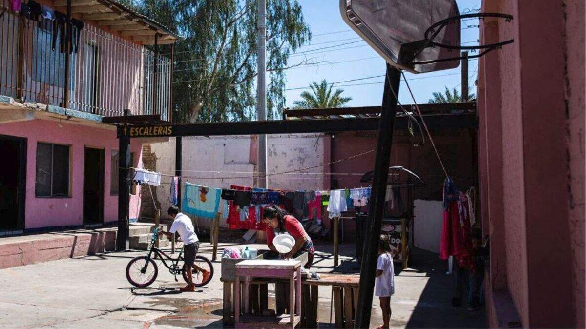 Tania (not her real name) washes clothes at a shelter in Mexicali where she stayed with her family for several weeks, first waiting to apply for asylum, and then waiting for a court hearing. A week after this photo was taken, she fainted in the heat and was hospitalized.