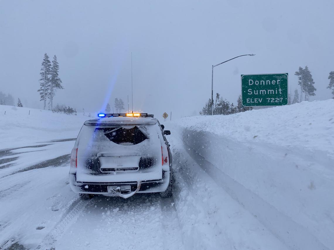 A California Highway Patrol vehicle drives through snow at Donner Summit on Sunday, Dec. 25. Interstate 80 was closed over the Sierra Nevada on Saturday due to whiteout conditions.