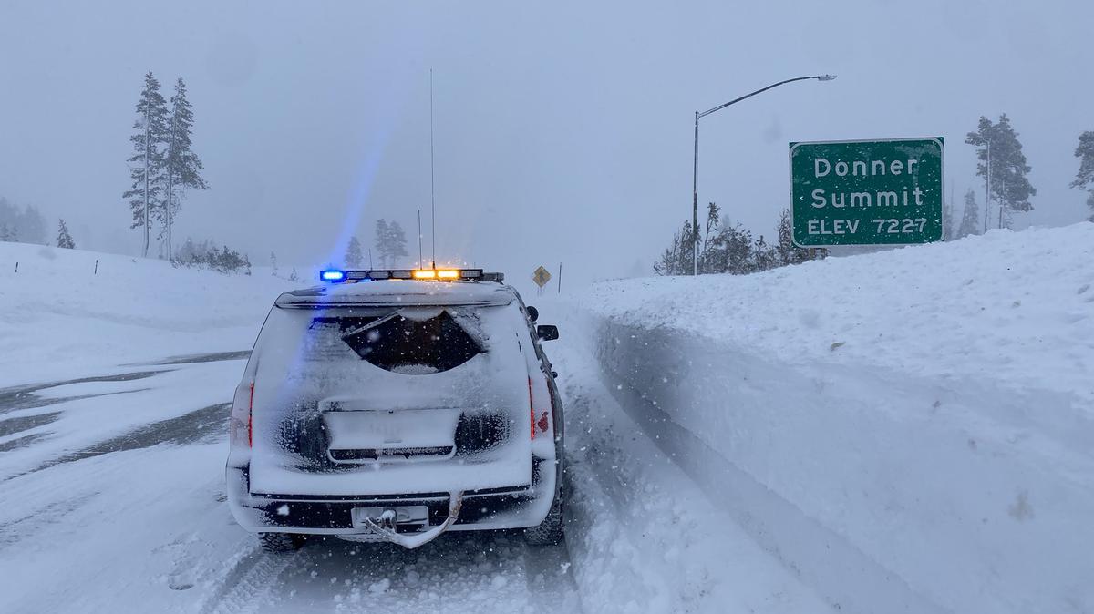 A CHP vehicle drives through snow at Donner Summit on Sunday, Dec. 25. Interstate 80 was closed over the Sierra Nevada on Saturday due to whiteout conditions.