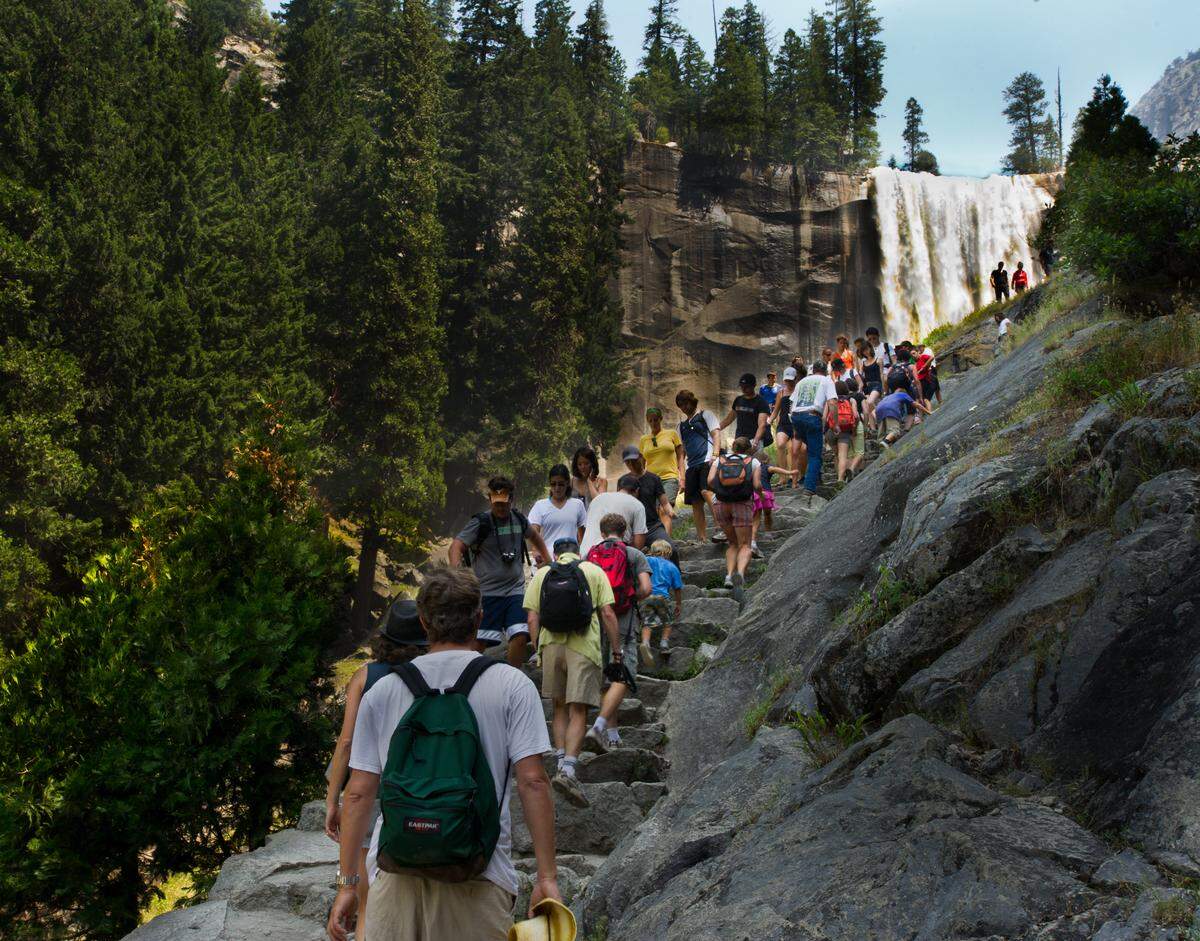 SECOND - Hikers make their way up the trail to Vernal Fall in the background at Yosemite Valley, August 10, 2011. 