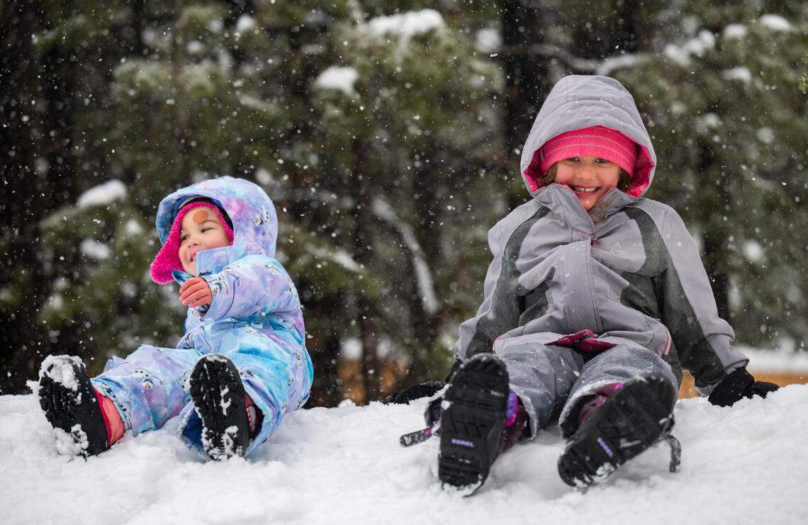 Madelyn Karimoto, 3, and sister Clara, 6, of Walnut Creek, make snow angels amid heavy snowfall in Tahoma in January.