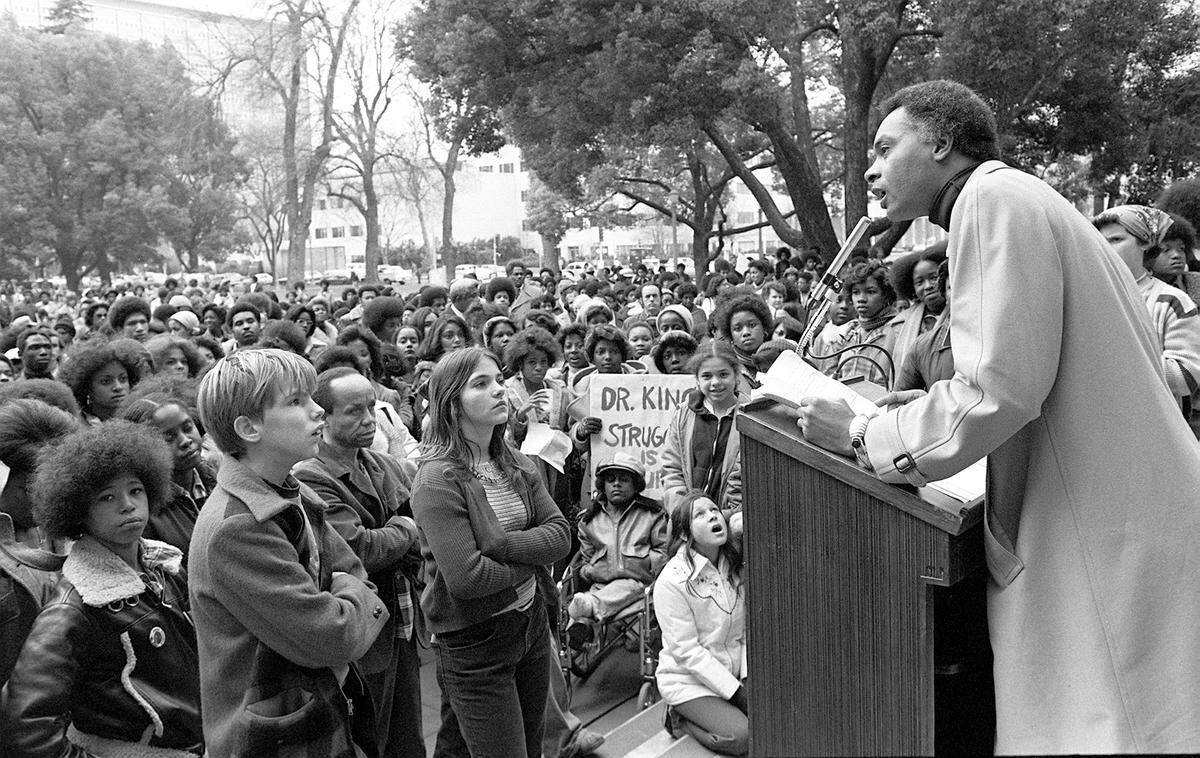 Then-Sacramento State professor David Covin, founder of the Sacramento Area Black Caucus, calls for the creation of a state holiday to honor Martin Luther King Jr. during a rally in front of 2,000 students on Capitol Mall on Jan. 14, 1977.