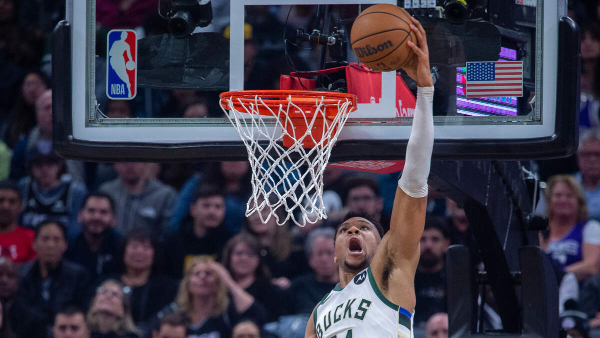 Milwaukee Bucks forward Giannis Antetokounmpo (34) reverse dunks the ball over Sacramento Kings forward Trey Lyles (41) in the first quarter during a game mat the Golden 1 Center in Sacramento, Monday, March 13, 2023.