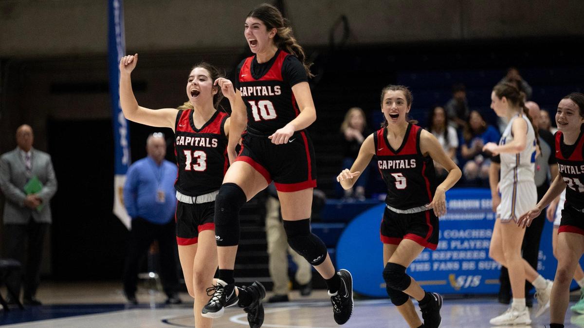 Sacramento Adventist Academy’s Victoria Fowler (10) celebrates with Bella Plesea (13) and Bella Plesea (5) after beating Faith Christian during the CIF Sac-Joaquin Section Division VI girls basketball championship game at UC Davis on Friday in Davis.