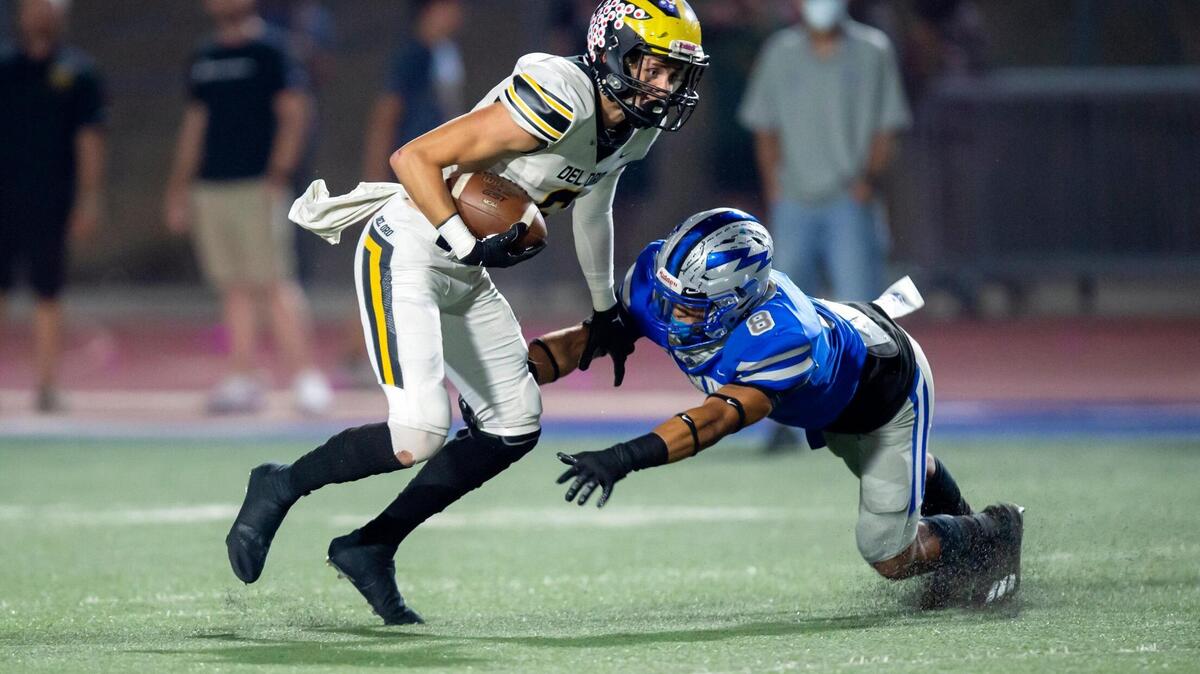 Del Oro’s Aiden Parry runs the ball with Rocklin’s Rio Patton defending during the first quarter in the game at Rocklin High School in Rocklin on Friday, Sept. 24, 2021. Rocklin won 38-3.