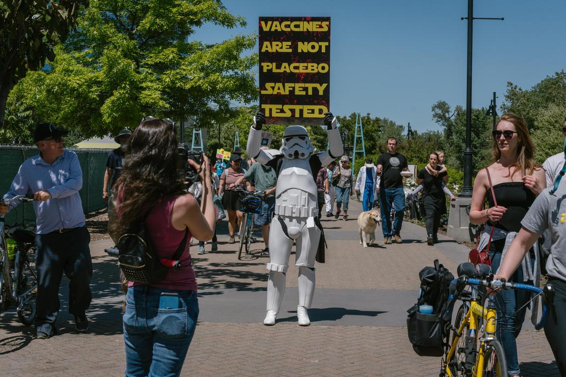 Joshua Coleman holds a sign at the March for Science at River Walk Park in West Sacramento on Saturday, May 4, 2019.