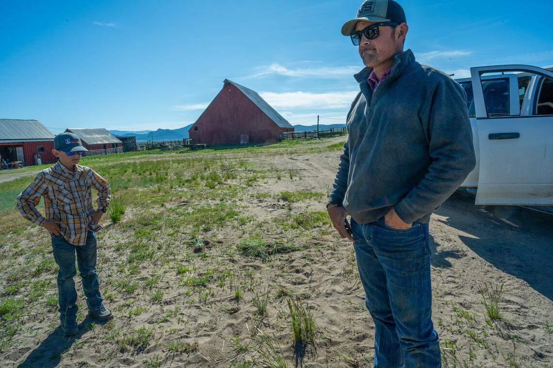 Dan Greenwood, right, and his son Waylon, 9, left, at his parent’s ranch in Sierra Valley in May. In April, Greenwood found possible wolf prints near footprints from where his sons and their cousins were playing the previous night. Greenwood said if a wolf endangers his children he would kill it with his bare hands.
