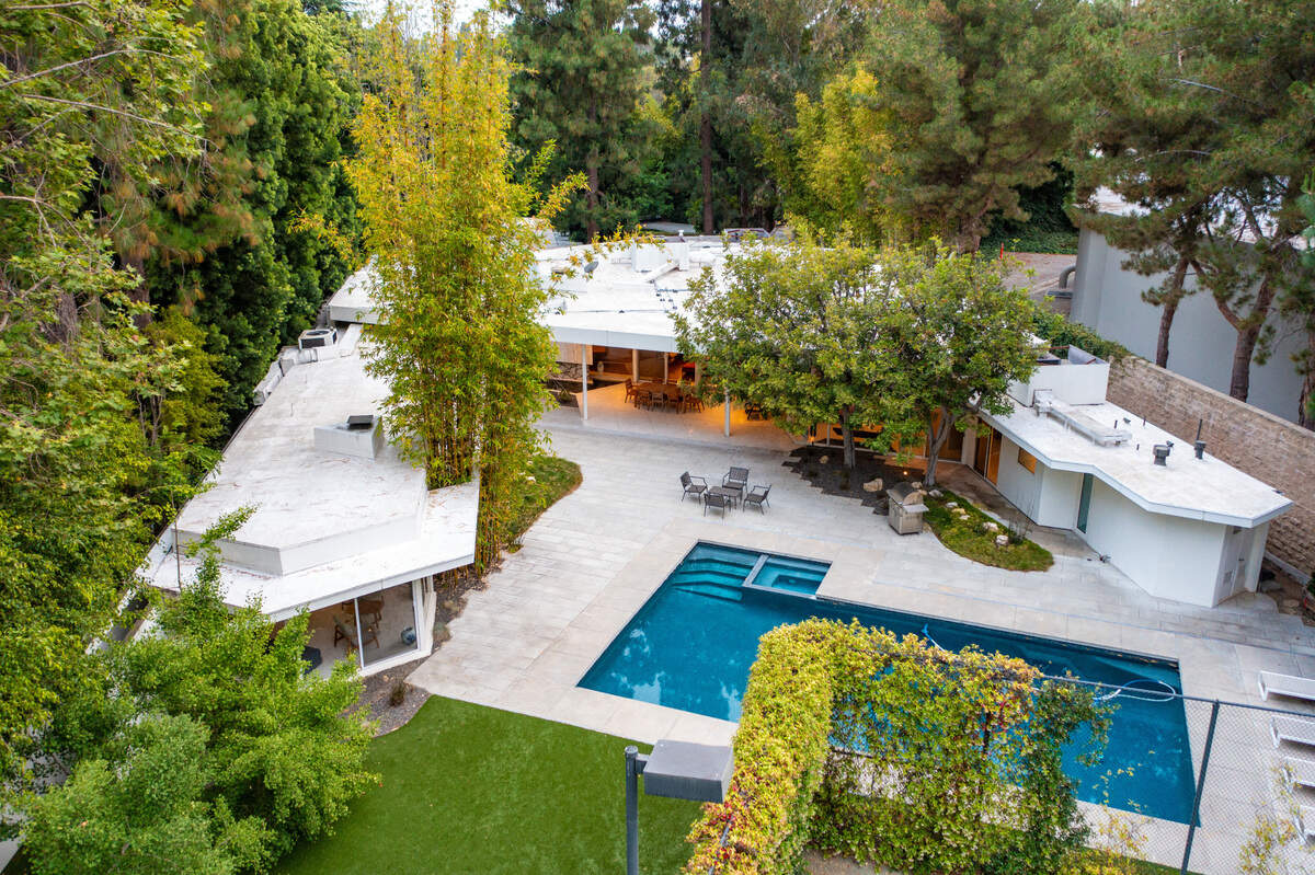 The grounds contain a swimming pool, tennis court and two-unit guest house.