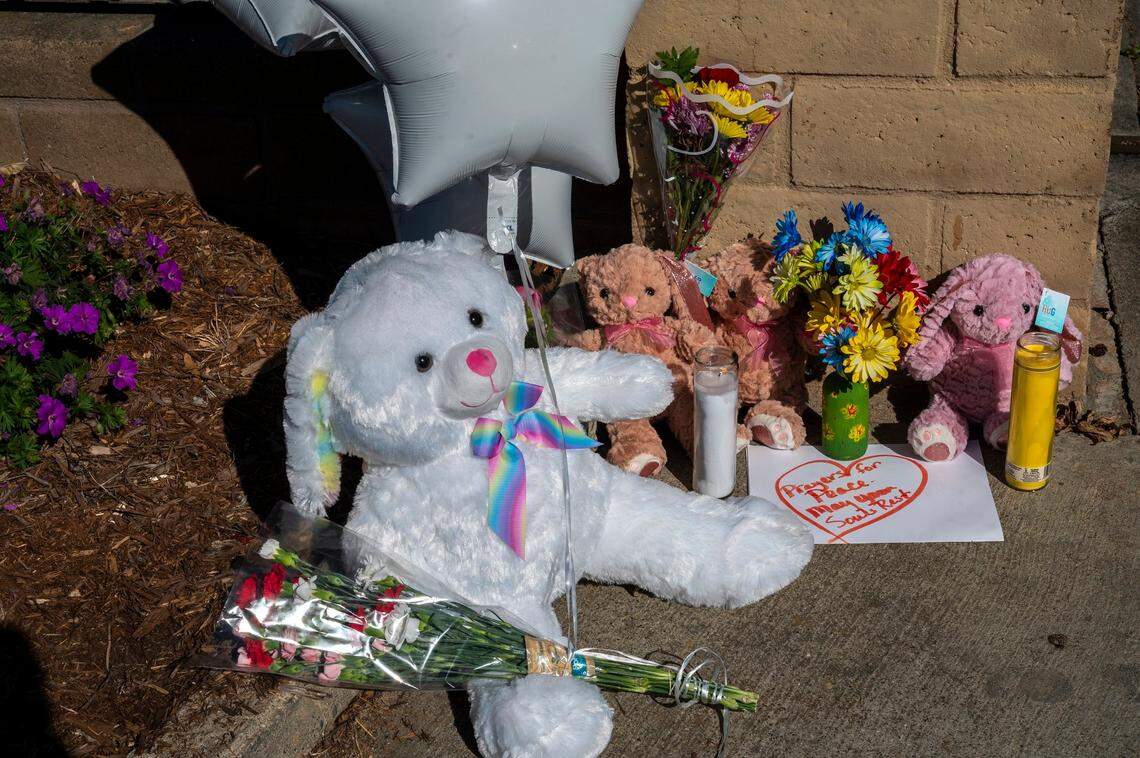 A large stuffed rabbit sits Tuesday next to three smaller rabbits along with balloons, flowers and candles at The Church in Sacramento on Wyda Way in Arden Arcade at a memorial for three children who were killed the night before by their father, who also killed the children’s chaperone and himself.