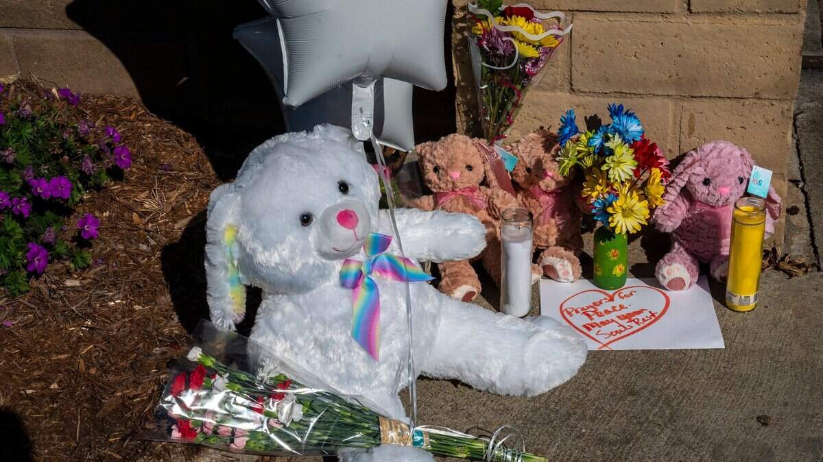 Un gran conejo de peluche junto a tres conejos más pequeños, globos, flores y velas en The Church in Sacramento en Wyda Way en Arden Arcade, el martes 1º de marzo de 2022, en una ofrenda para tres niñas que fueron asesinadas la noche anterior por su padre, que también mató al acompañante de las pequeñas y luego se suicidó.