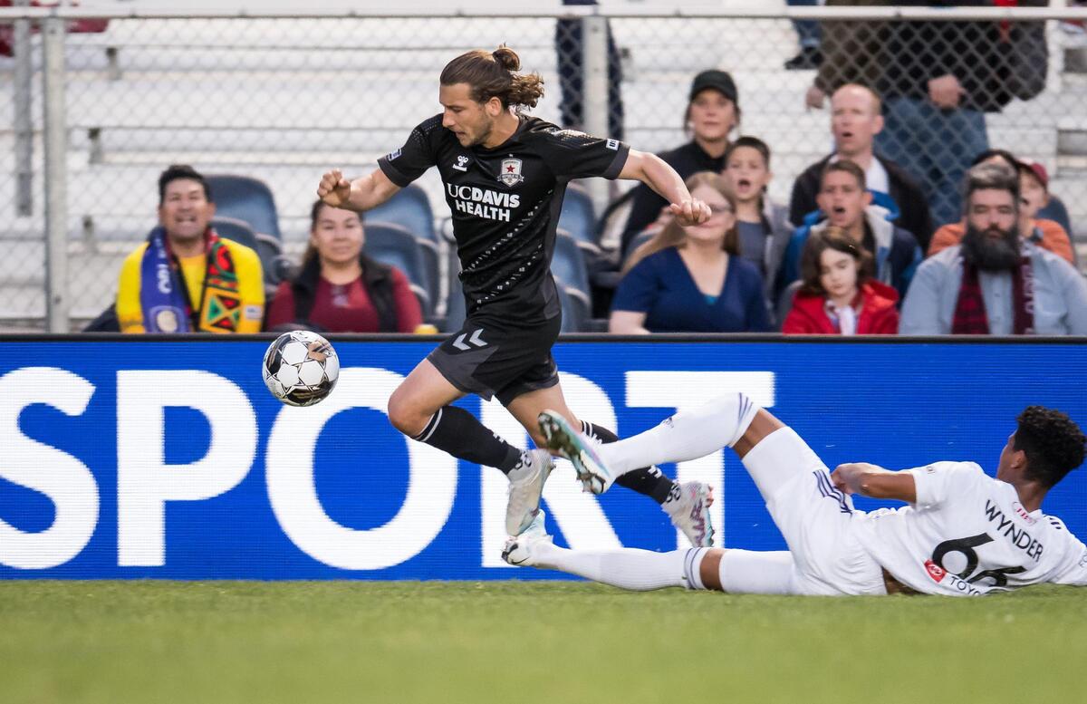 Sacramento Republic FC forward Russell Cicerone (11), left, evades Louisville City FC defender Joshua Wynder (66) and crosses the ball for teammate Jack Gurr (2) to score during the first half of the USL soccer game Saturday, April 1, 2023, at Heart Health Park. Sac Republic shut out Louisville 5-0.