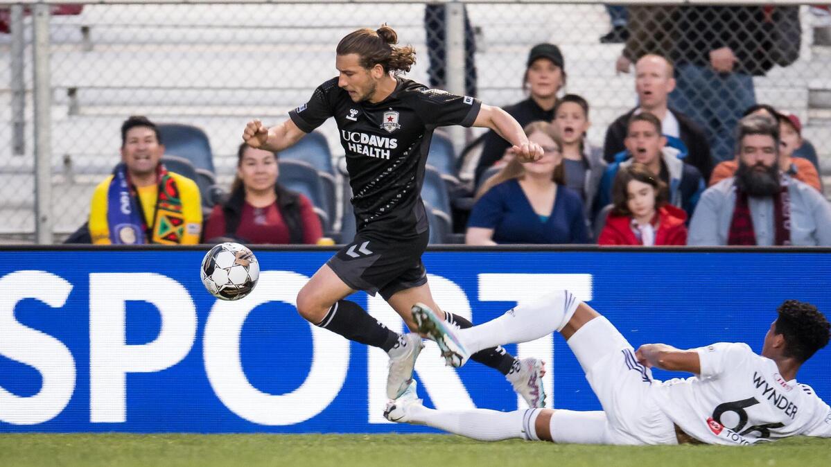 Sacramento Republic FC forward Russell Cicerone (11), left, evades Louisville City FC defender Joshua Wynder (66) and crosses the ball for teammate Jack Gurr to score Saturday at Heart Health Park.
