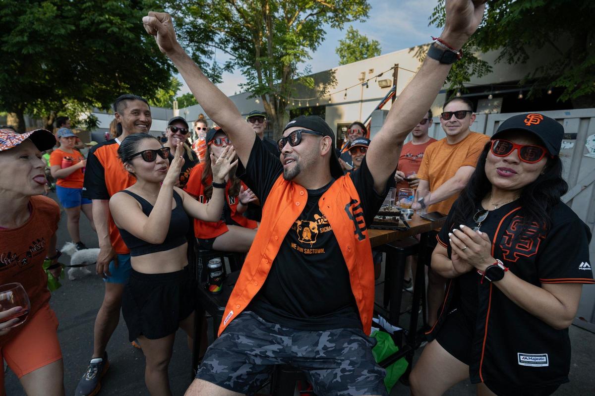 Edy Flores celebrates after his friends sang happy birthday to him following the Sloppy Moose Running Club three-mile run that began and ended at Bike Dog Brewing Company in West Sacramento on June 20, 2024.