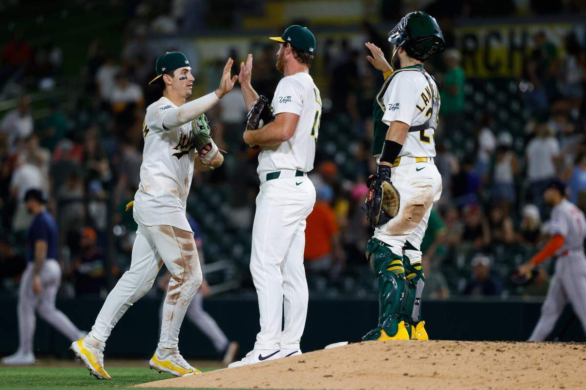 Sep 23, 2025; West Sacramento, California, USA; Athletics left fielder Tyler Soderstrom (21) celebrates with pitcher Michael Kelly (49) after a game at Sutter Health Park. Mandatory Credit: Sergio Estrada-Imagn Images