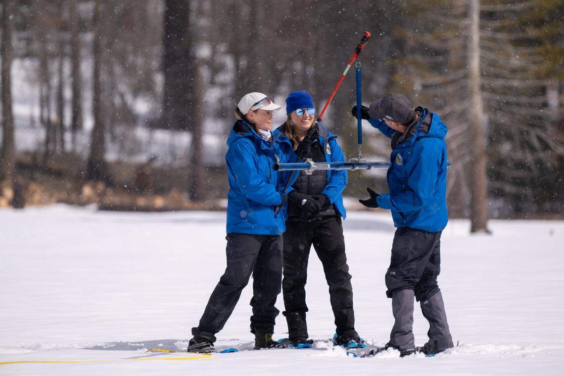 The California Department of Water Resources’ Laura Hollender, left, Manon von Kaenel, center, and snow surveys manager Andy Reising measure the snow in the fourth manual snow survey of the season Friday at Phillips Station in El Dorado County.
