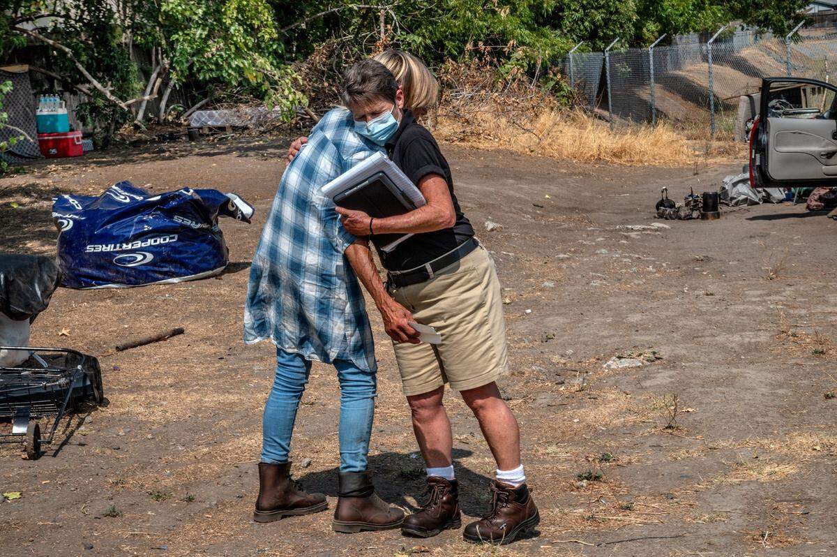 Tracey Knickerbocker, right, who was homeless for 10 years and is now a a member of the Sacramento Department of Community Response, hugs Cindy Mattison after answering a 311 call on Wednesday. Mattison needed a new state ID card and refills of her medication for post-traumatic stress disorder.