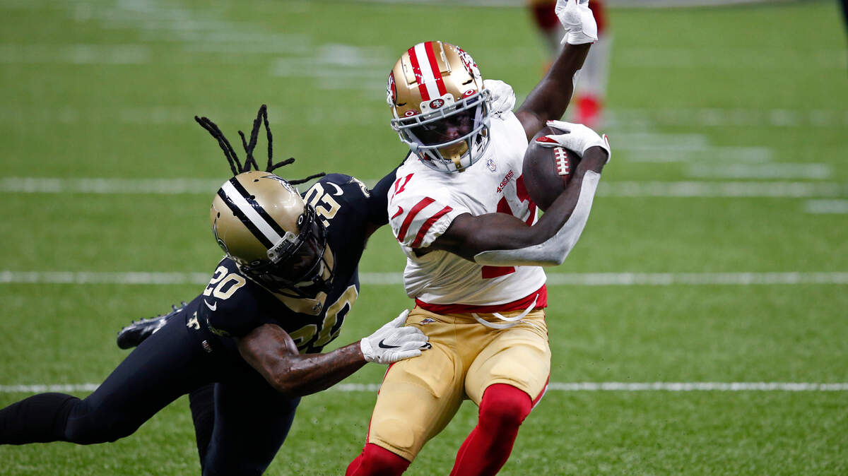 San Francisco receiver Brandon Aiyuk tries to evade New Orleans cornerback Janoris Jenkins in Sunday’s game.