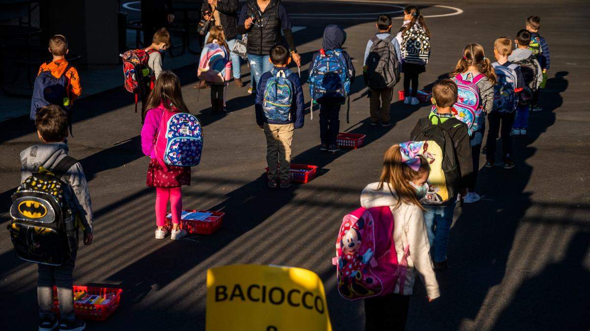 School children wait in socially distanced lines before they start their first day of in-class instruction at Folsom Hills Elementary School on Thursday, Nov. 12, 2020. The Folsom Cordova School District will offer a virtual academy in the fall.