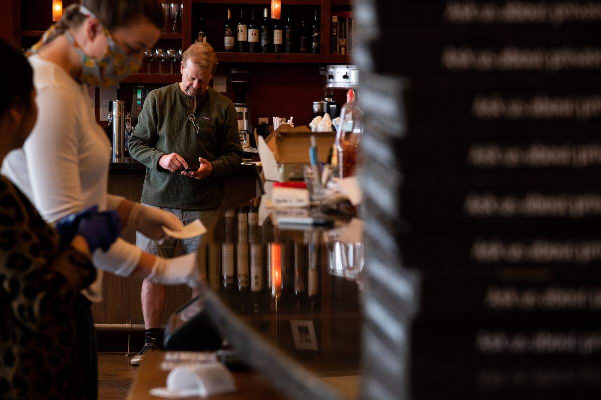 OneSpeed chef/owner Rick Mahan stands near the closed bar in his East Sacramento restaurant Wednesday, April 8, 2020, as takeout orders are processed across the closed dining room. “This goes deep, and a lot of people have lost their retirement, a lot of people will not have disposable income and a lot are not employed any longer,” he said, speaking of the challenges ahead for his business and especially for newer restaurants.