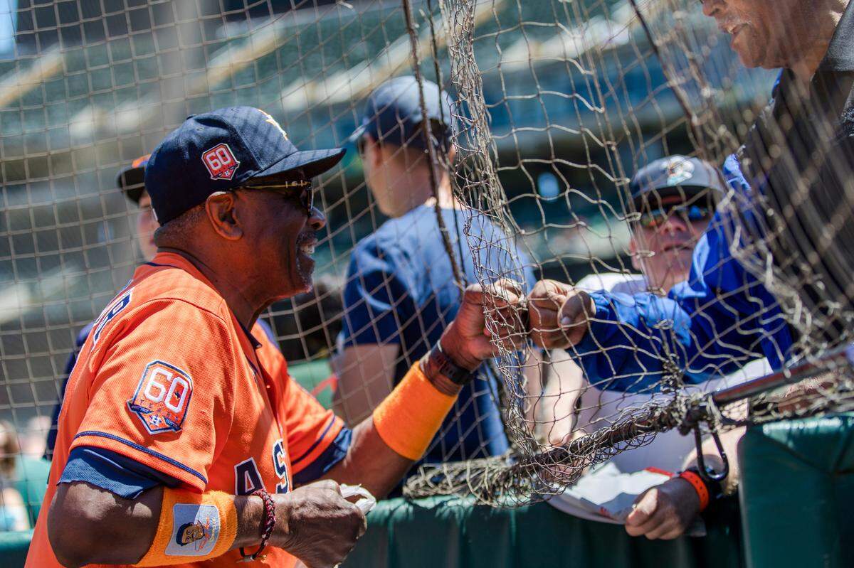 Houston Astros manager Dusty Baker fist-bumps a fan before a game against the Athletics in Oakland on Monday, May 30, 2022.