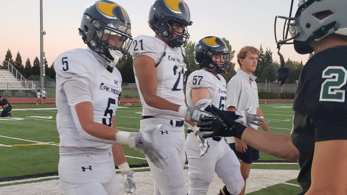 Oak Ridge captains shake hands with Granite Bay captains before Friday night’s game at Granite Bay High School. The Trojans defeated the Grizzlies, 30-17.