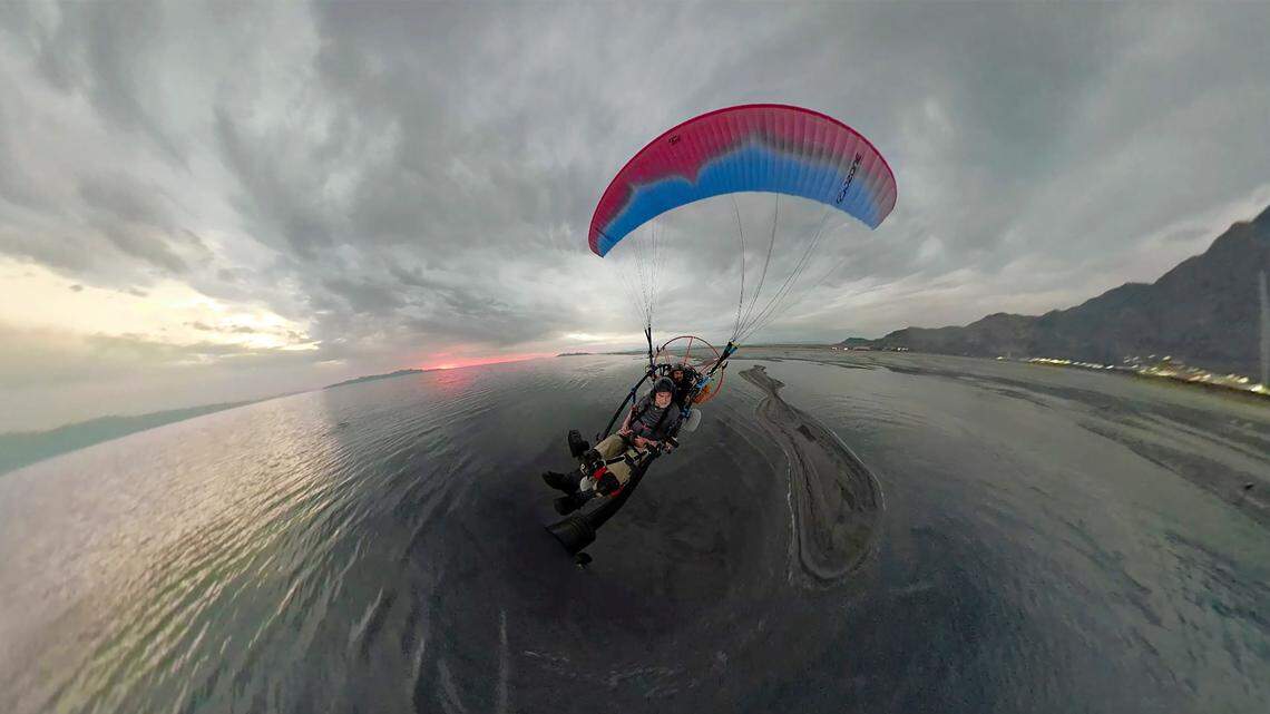 Robert Atkinson flies over the Great Salt Lake during a tandem paramotoring flight in June, near Salt Lake City. In Hawaii, firefighters airlifted a 27-year-old paraglider who became stranded on Kamehame Ridge to safety Sunday, Jan. 9, Honolulu fire officials say.