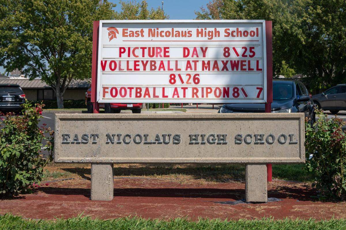 The school sign at East Nicolaus High School in Sutter County on Thursday advertises picture day, volleyball and football after the campus shut down because of an outbreak of COVID-19. Staff and students are quarantined at home for 10 days.