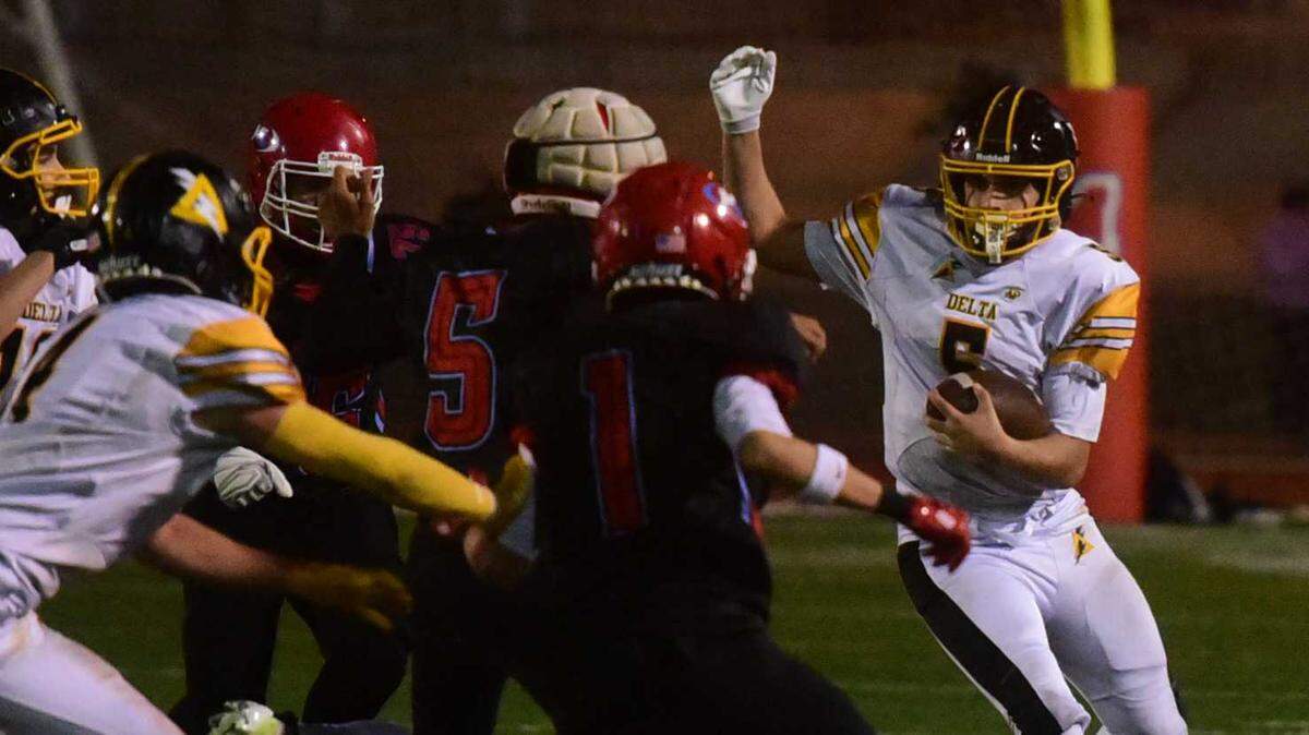 Delta quarterback Chase Parkinson (5) barrels into Mira Loma defenders in the fourth quarter of a CIF Sac-Joaquin Division VIII semifinal game against Mira Loma on Friday, Nov. 21, 2025, at El Camino High School in Arden Arcade, Calif. The top-seeded Matadors defeated the Saints, 48-34.