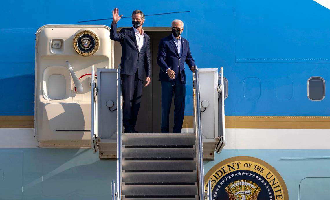 Gov. Gavin Newsom, left, waves before boarding Air Force One with President Joe Biden after the visit to Mather Airport on Monday, Sept. 13, 2021. Biden visited the Sacramento region to survey wildfire damage, before heading to Long Beach to campaign for Newsom in the recall election.