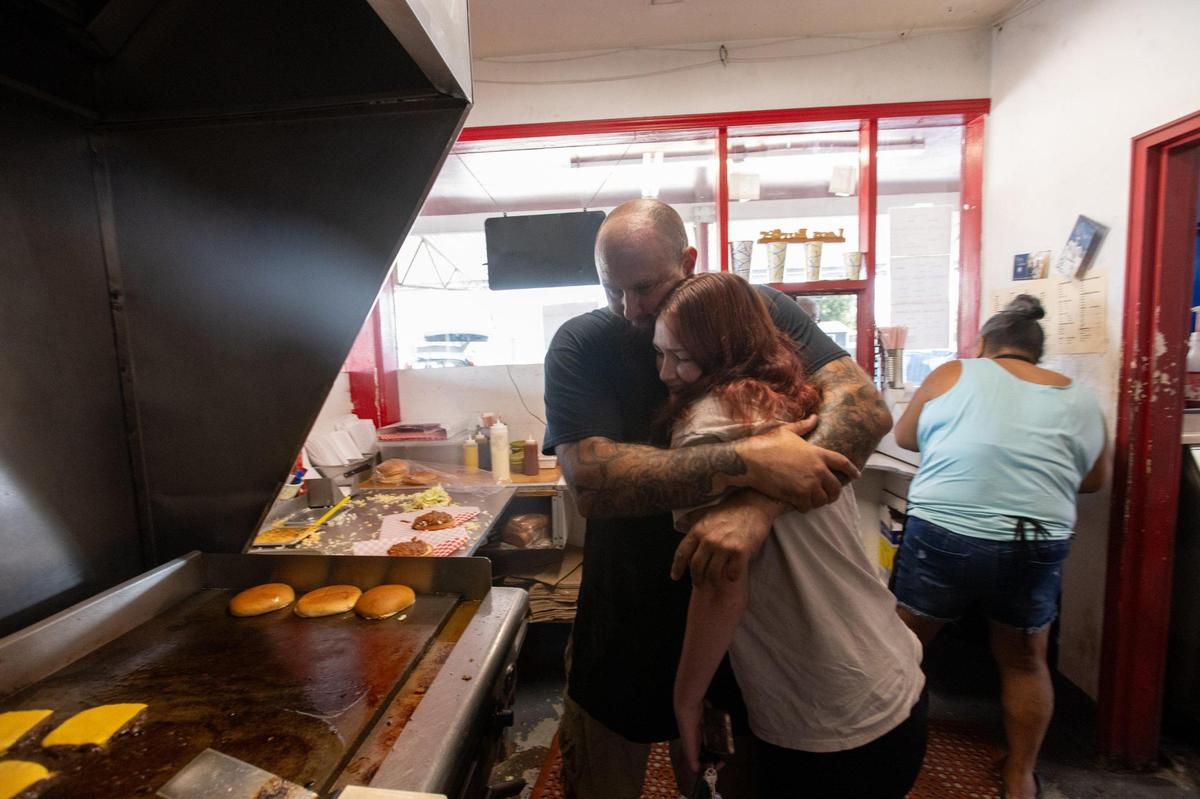 Robert Kitchens hugs his daughter Emylee at Lou’s Burgers on Friday in North Highlands.