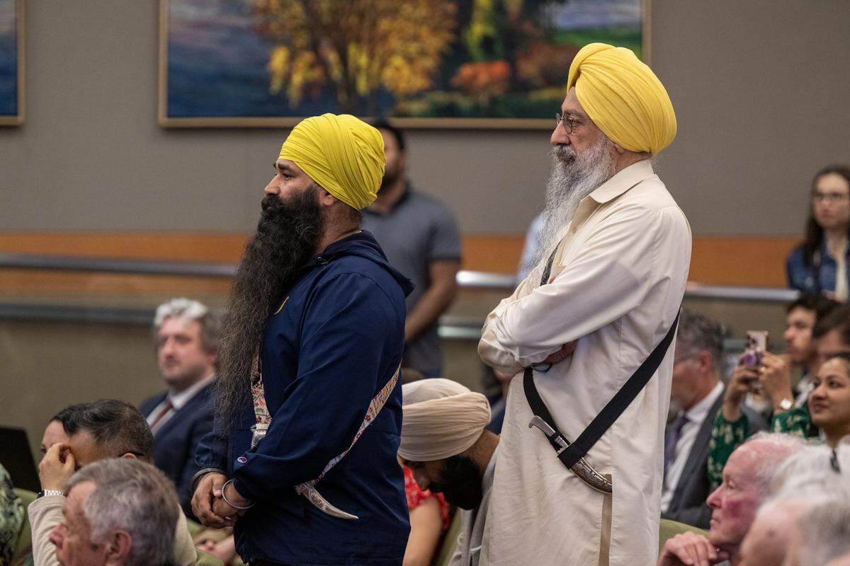 Mandeep Singh, left, and Dr. Gurtej Singh wear kirpans as they join dozens of Sikh community members on Tuesday at the first Sacramento City Council meeting where the ceremonial blades were allowed after the council created a religious exemption for the weapons.