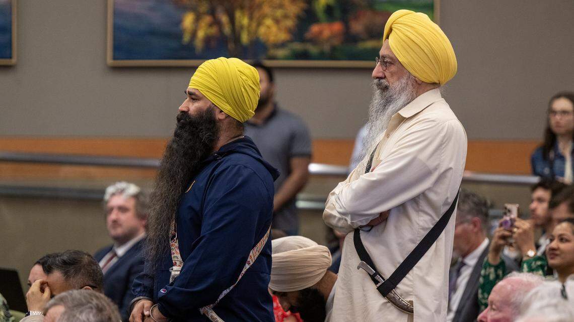 Mandeep Singh, left, and Dr. Gurtej Singh wear kirpans as they join dozens of Sikh community members Tuesday at the first Sacramento City Council meeting where the ceremonial items were allowed after the council created a religious exemption for the weapons. 