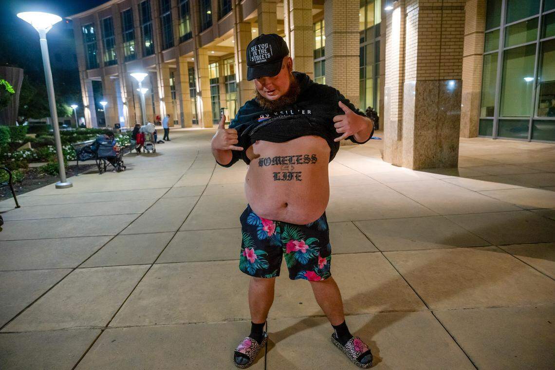 Daniel Ladd shows off his “Homeless for Life” tattoo in support of the unhoused sleeping outside Sacramento City Hall on Aug. 27, the night before an ordinance took effect that prohibits outdoor sleeping at the building.