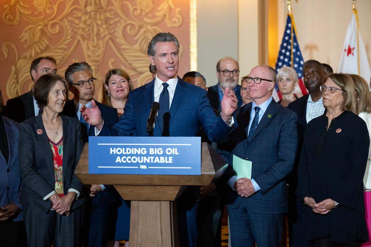 Gov. Gavin Newsom, joined by legislators and community leaders, talks to the media after signing bill at the state Capitol on Monday, Oct. 14, 2024 in Sacramento. 