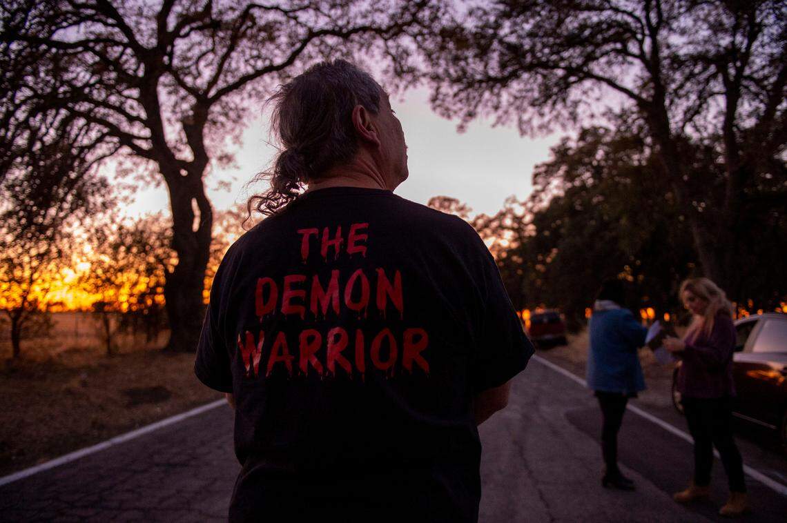 Ghost hunter, Paul Dale Roberts, of Halo Paranormal Investigations, wears a shirt that says, “The Demon Warrior” while investigating spiritual phenomenon, Sunday, Oct. 27, 2019, on Dyer Lane.