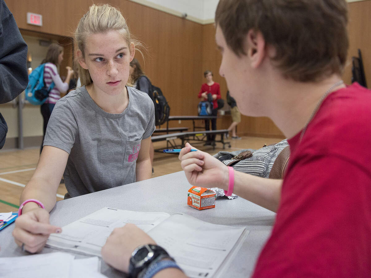 Vena Sexton, 16, left, gets some last-minute tutoring from senior Jacob Williams before she takes the PSAT test at George Washington Carver School of Arts and Science on Wednesday, Oct. 14, 2015, in Sacramento.