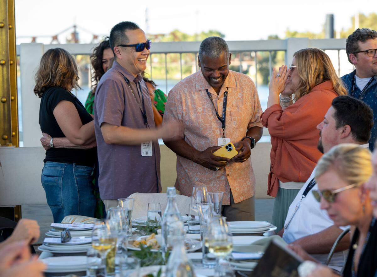Sacramento City Manager Howard Chan, left, Councilman Rick Jennings and state Sen. Angelique Ashby talk at the Tower Bridge Dinner on Sunday.