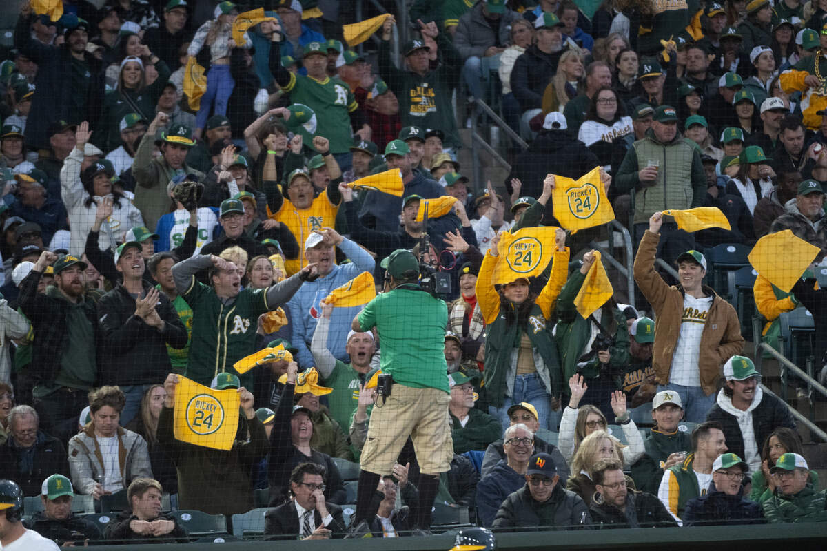 Athletics fans react to a TV camera during the first Major League Baseball game at Sutter Health Park in West Sacramento on Monday.