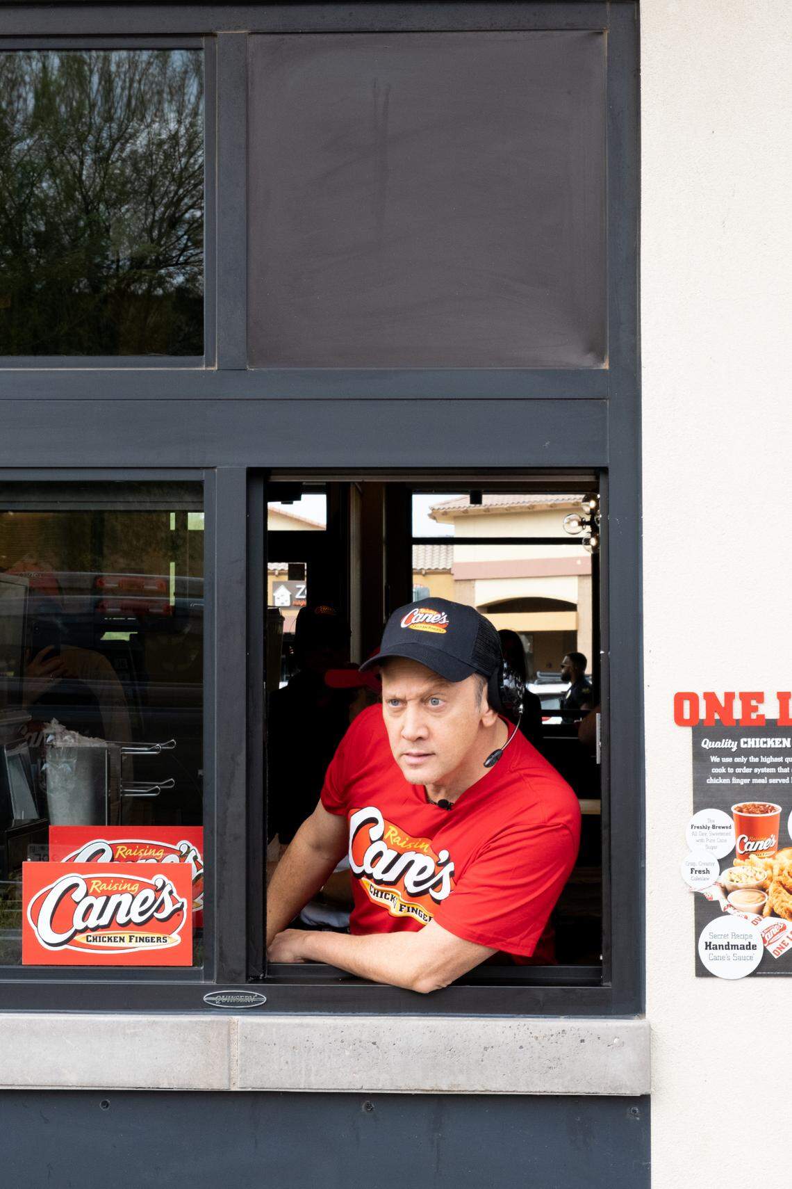 Rob Schneider works the drive-thru at Raising Cane’s in Phoenix, Arizona.