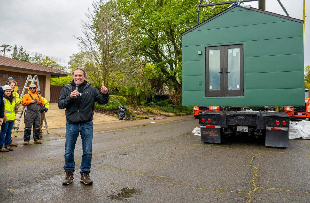 Mike McNamara, the CEO of Samara, presents the ADU that will be dropped into the backyard of a residence located at 6040 13th Street on Thursday.