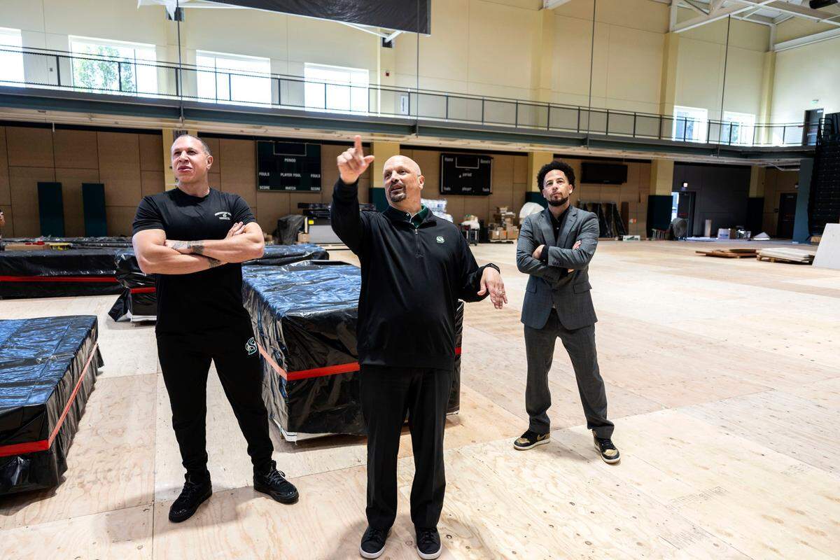 Sacramento State men’s basketball coach Mike Bibby, and president Luke Wood listen to director of athletics Mark Orr as he explains the features of The Well on Friday. The Well is being re-designed from a student fitness and health facility to be the basketball venue for the school's sports teams. 